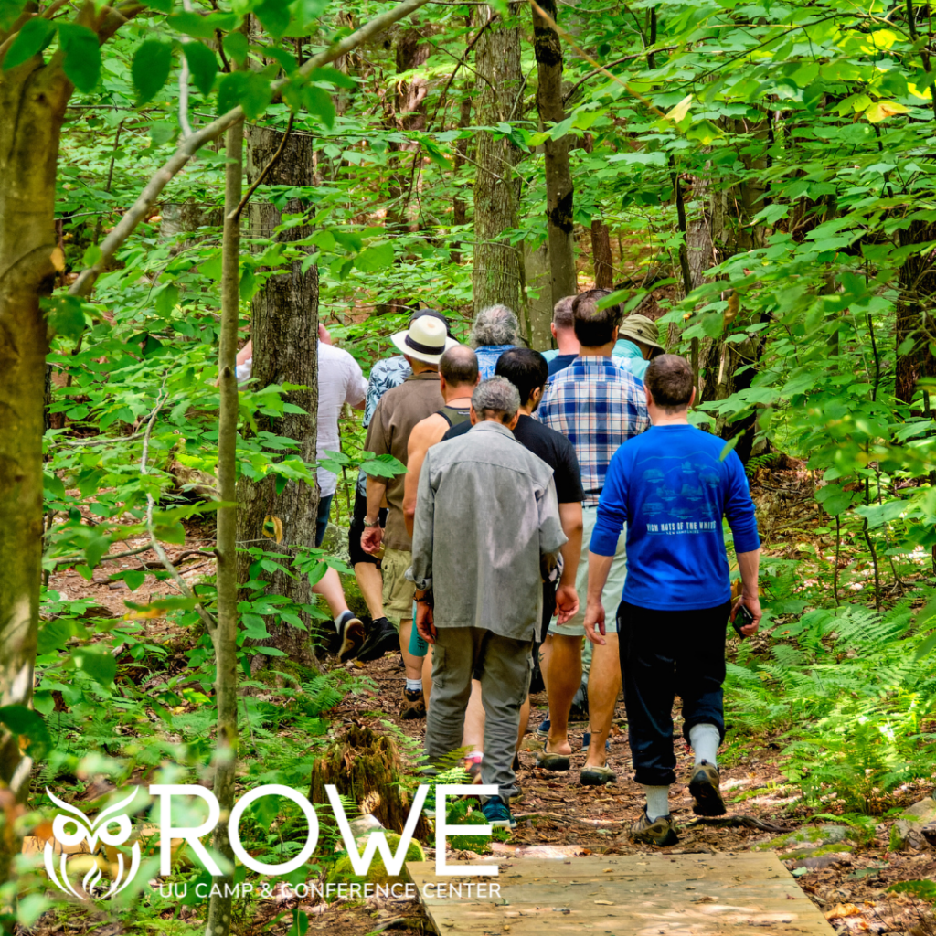 An adult Community walking thought the Woods at Rowe Center