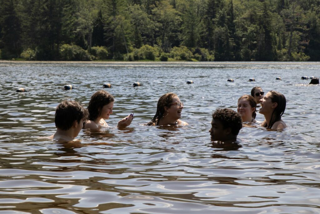 Campers swimming together in Pelham Lake