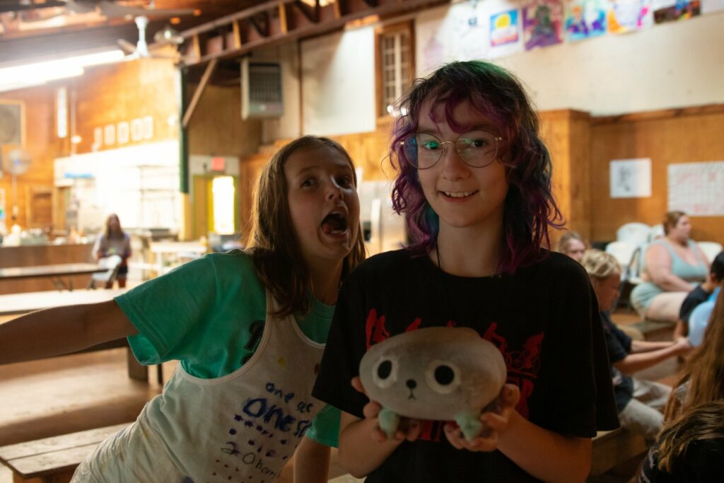 Two campers smiling in the Rec Hall at Rowe Camp
