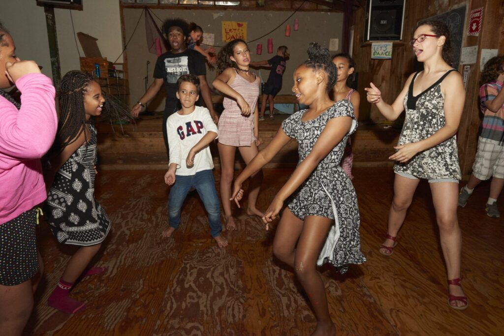 Campers dancing together in the Rec Hall at Rowe Camp